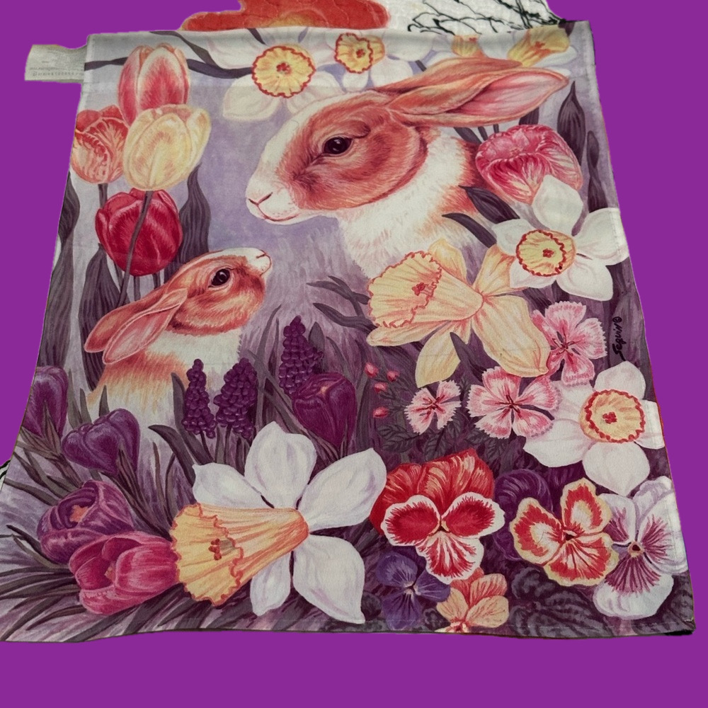Cute mommy & baby bunny hiding in a garden flag.